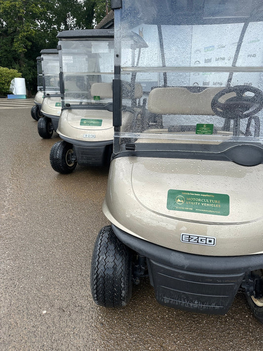 Fleet of EZGO RXV golf buggies hired to a club for use during a busy event.