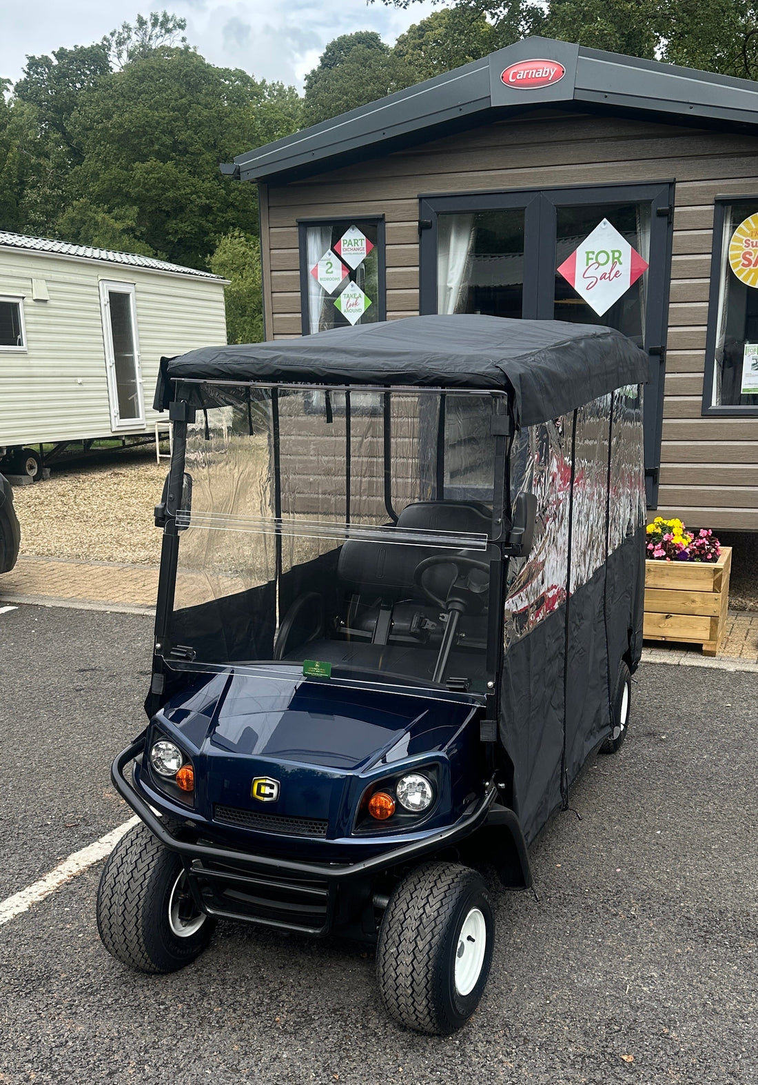 Cushman Shuttle 6 with lithium battery and weather enclosure at a northern caravan park.