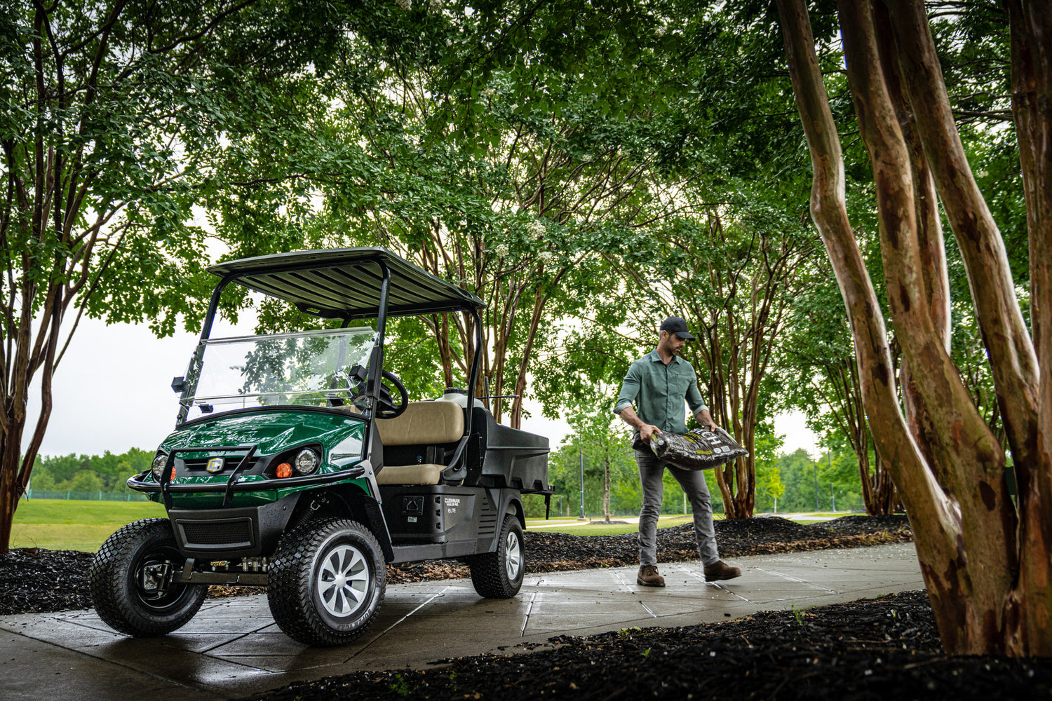 blue cushman hauler pro electric utility vehicle, powered by a lithium battery and fitted with a roof and screen
